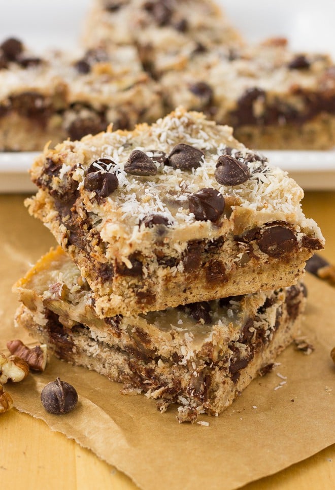 Image shows a close up of two magic cookie bars stacked on one another on a table.